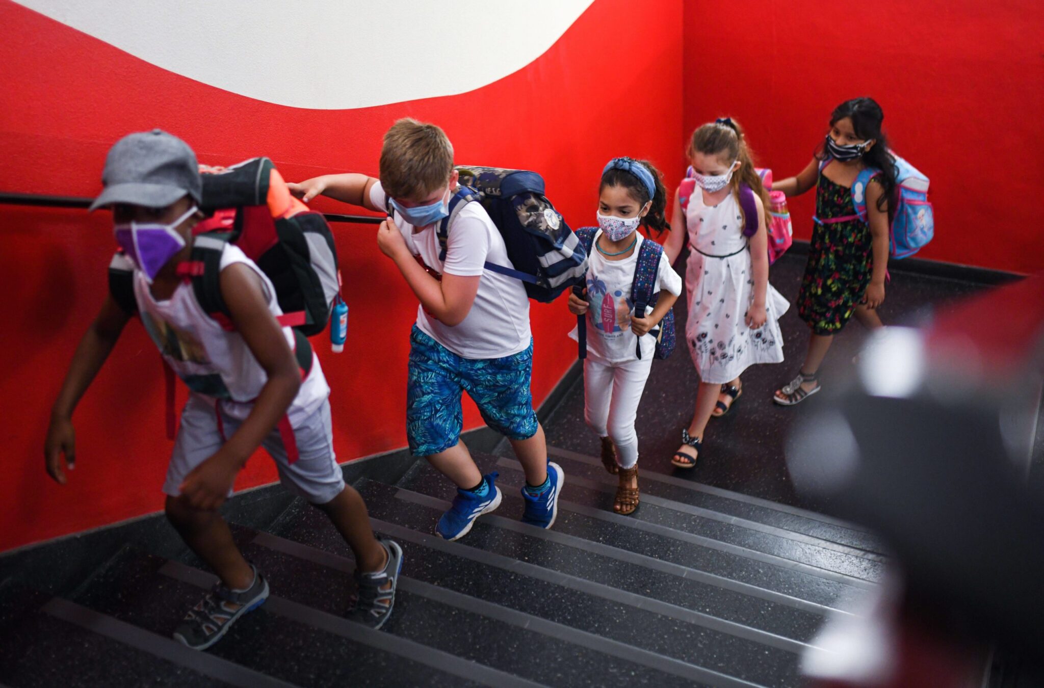 Students wearing masks in a hallway